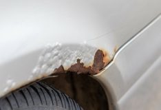 Rust on a silver car over the wheel